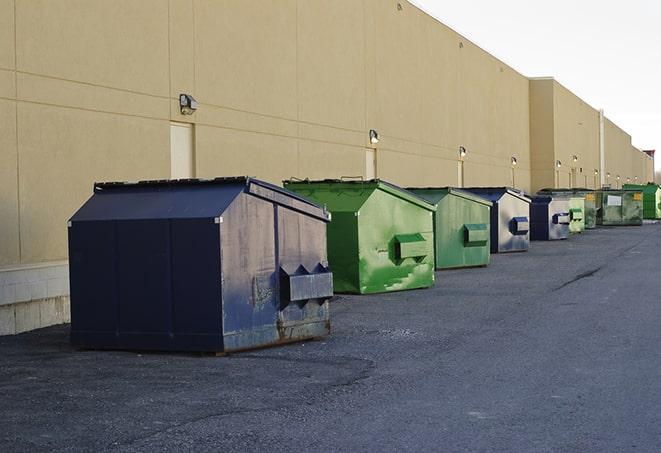 a row of industrial dumpsters at a construction site in Locust Grove